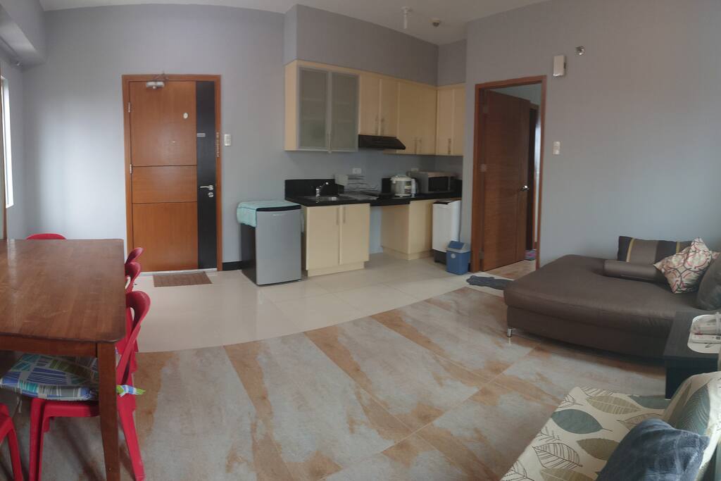 KITCHEN: Cupboards with toaster, Sink w/ sponge & soap, 3cu.ft. Fridge, Kettle, Dish rack; complete w/ 4 Plates, 4 pairs Spoon & fork, knife and chopping board, Microwave and bin 1 hub Induction cooker, Rice cooker, hotpot, wok and a cooking utensil