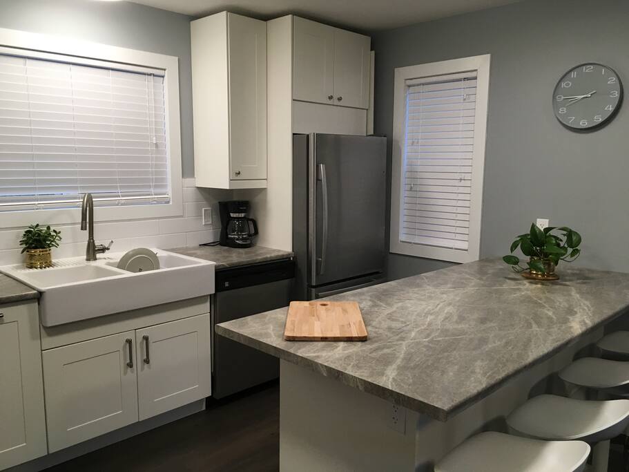 Brand new kitchen with deep double farmer sink, dishwasher, stove, fridge and freezer with ice machine