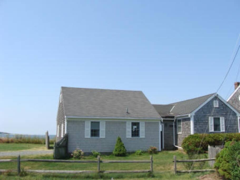 Driveway on the left, view from the street. Lewis Bay and the beach is just on the other side of the house!