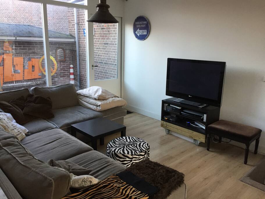 Big couch with TV (via computer) with Netflix and an outside terrace