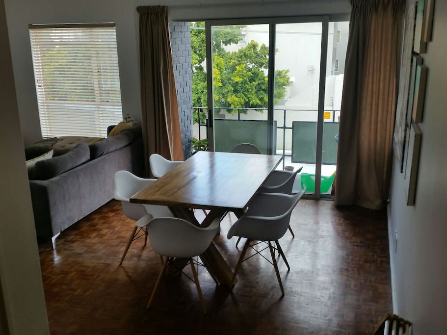 The dining area leads onto the sunny balcony. Both the lounge and dini g room get lots of sun in the afternoon, so it's great for sundowners.