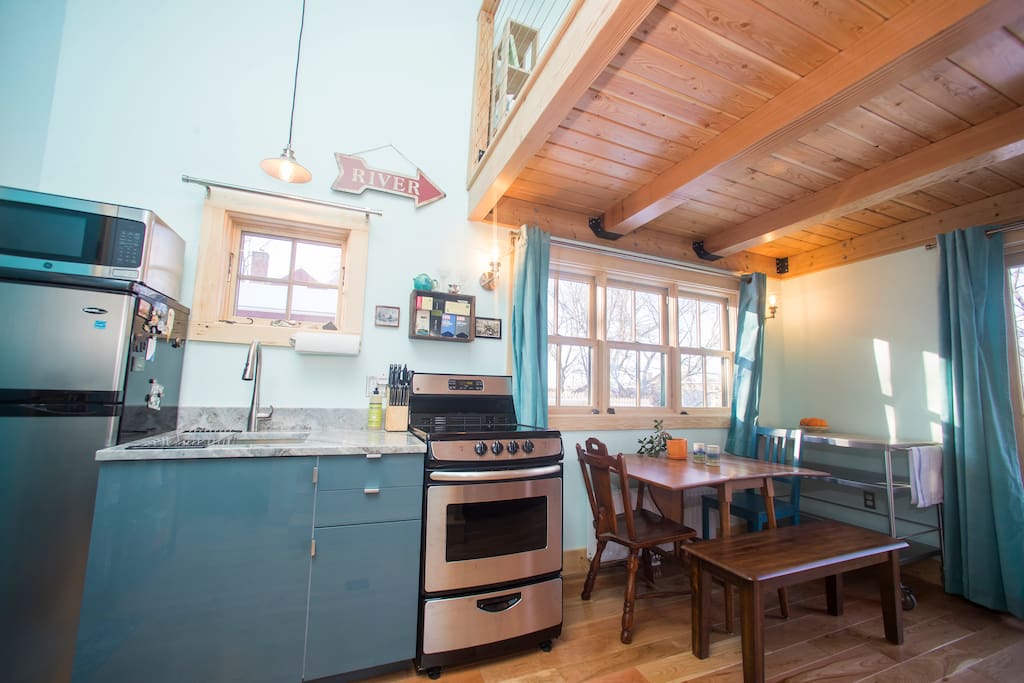 Loft style space with small kitchen & open concept plan.