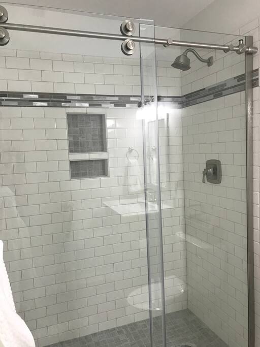 Master bathroom with new tile, fixtures, faucets, toilet, and vanity.