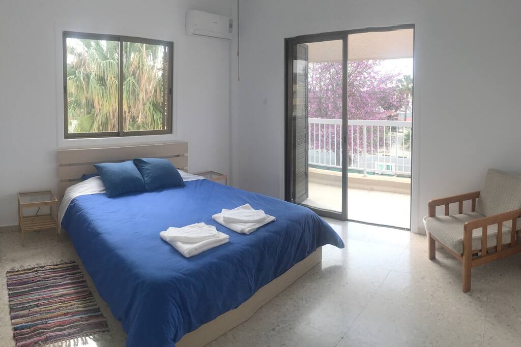 The master bedroom - king size double bed, black out shutters and air conditioning. Very large room with reading chair