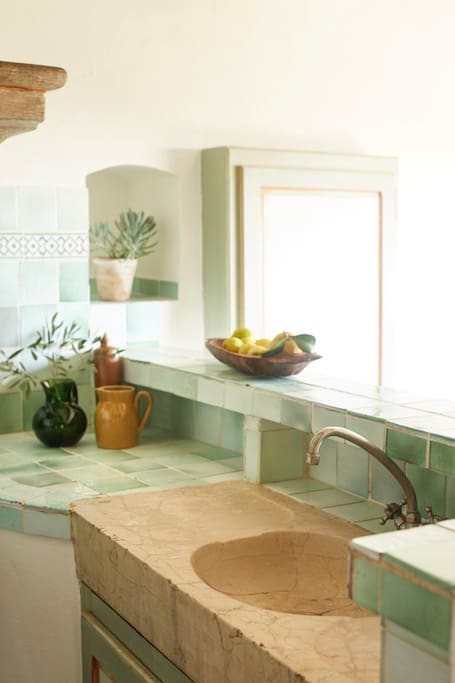 Green tile backsplash and countertop in a French Country kitchen #Frenchcountry #kitchendesign #kitchentile