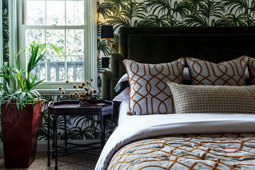 The Plantation Suite - Features a King Bed, ensuite, hallway, settee, wardrobe, bench and desk.