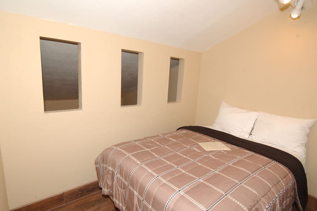 Private bedroom with double bed and attached private bathroom.