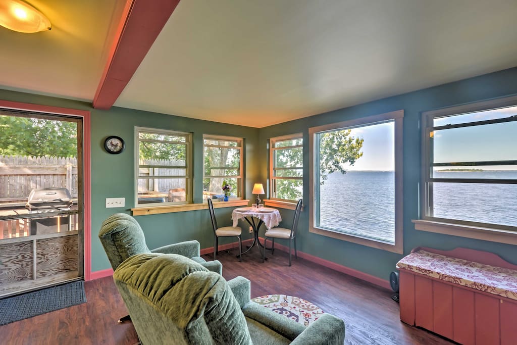 The open living area is filled with natural light, pouring from the windows throughout the cottage.