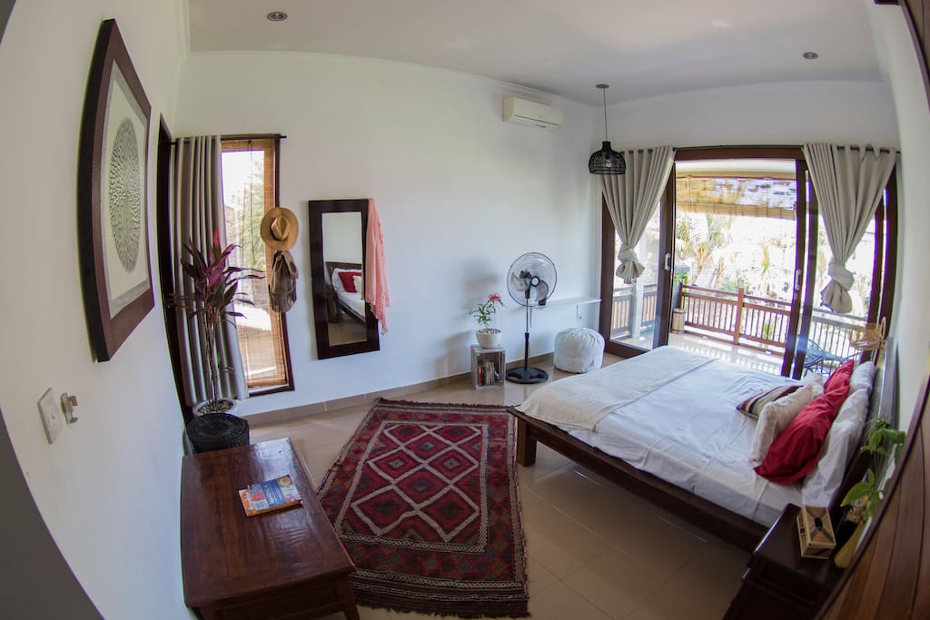 Upstairs Bedroom 2 with large balcony and rice field views.