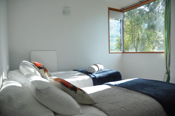 2nd bedroom enjoys north facing sunny bush views.  Two large single beds, leaves plenty of room for guests