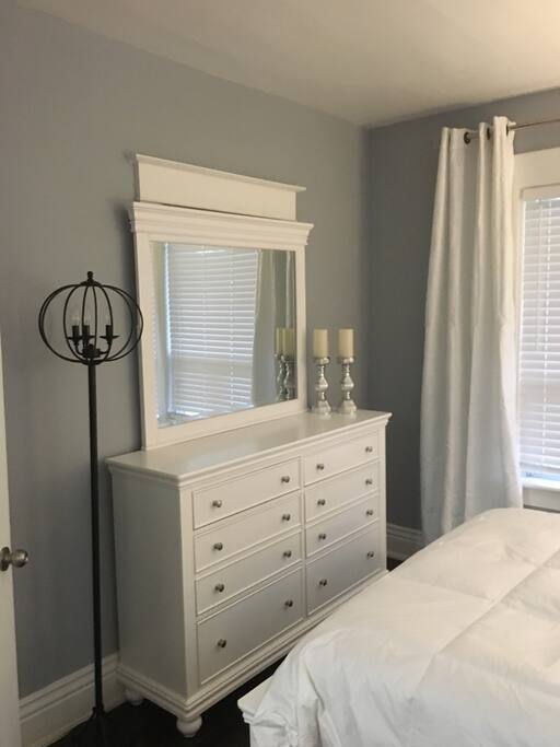 Master bedroom with dresser and mirror
