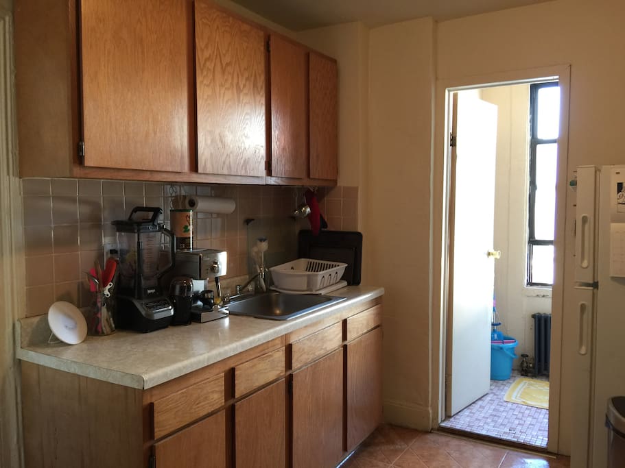 Kitchen with big sink, fridge, stove, and tons of appliances.