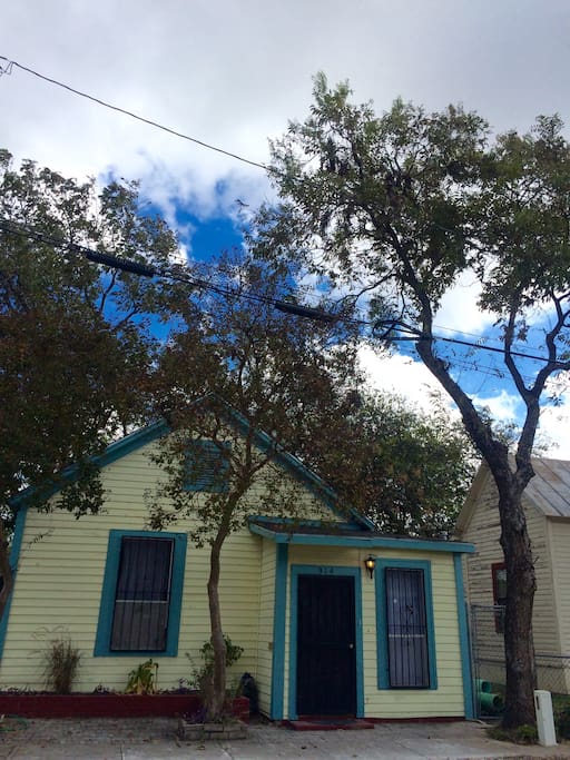 Shady cottage is surrounded by crepe myrtles and pecans.