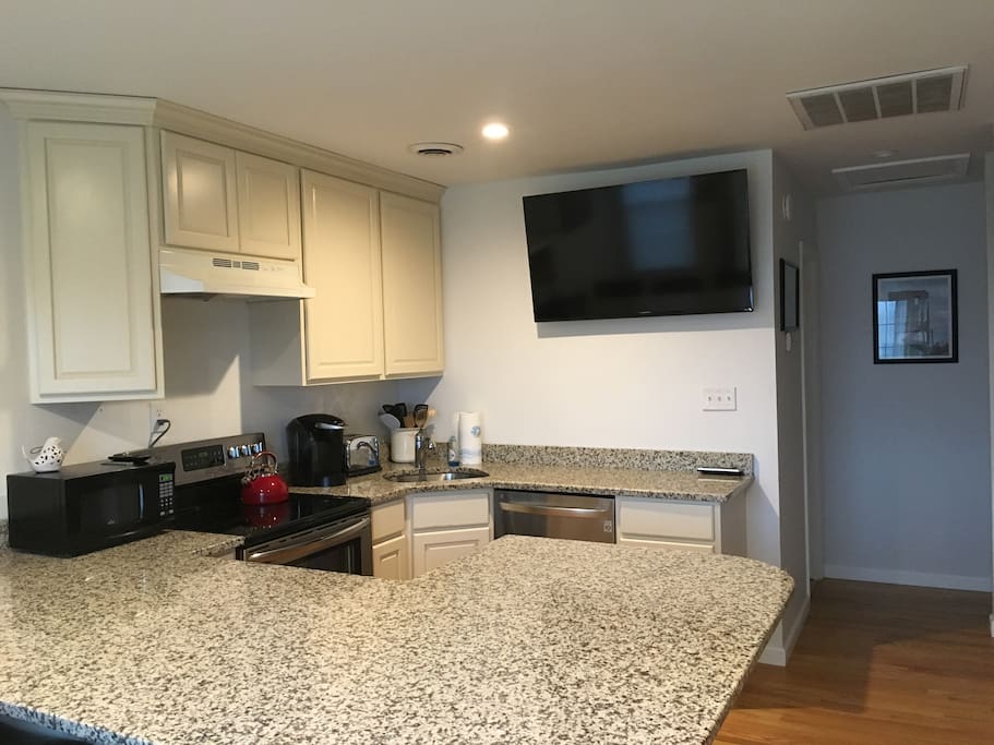 Large flat screen TV in the Living Room/Kitchen area with cable TV