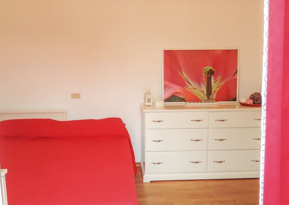Sunny colorful room with new queen zone memory foam mattress, large chest of drawers, large modern corner closet, private door to balcony and view of the lovely Pinon trees.