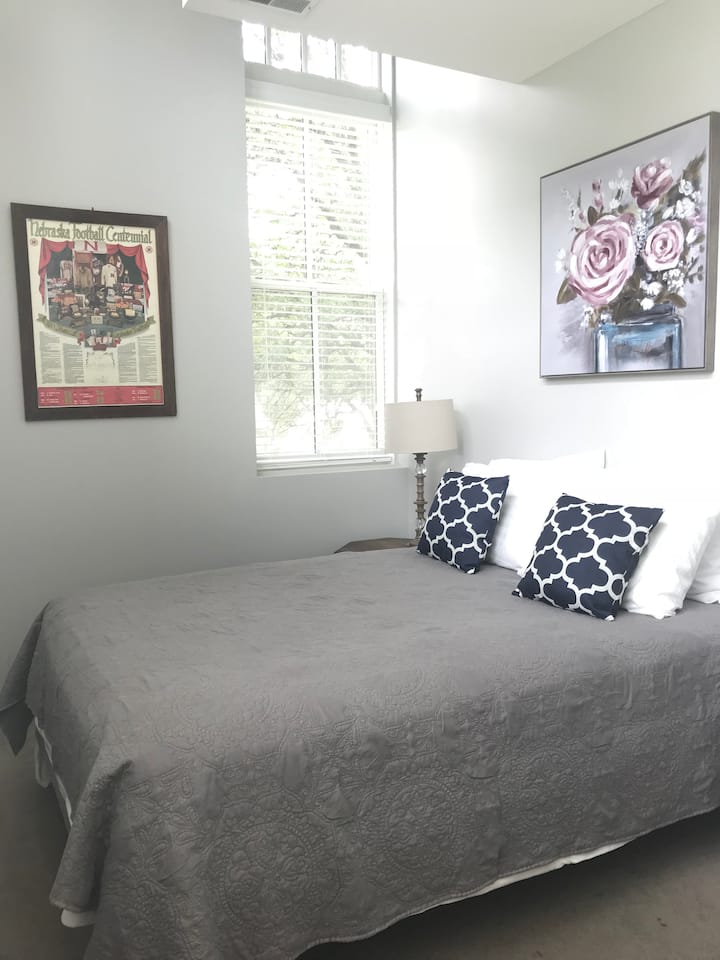 Guest bedroom with a queen sized bed. This is a small bedroom that doesn’t have a door. This bedroom also has 5 windows that provide an abundance of natural light. 