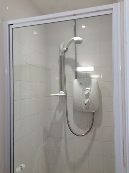 Shower over bath with towels provided.