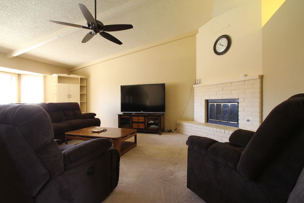 Large living room with 17' ceilings and gas fire place