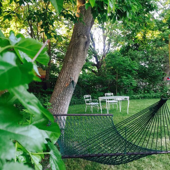Large quiet backyard with hammock and dining areas
