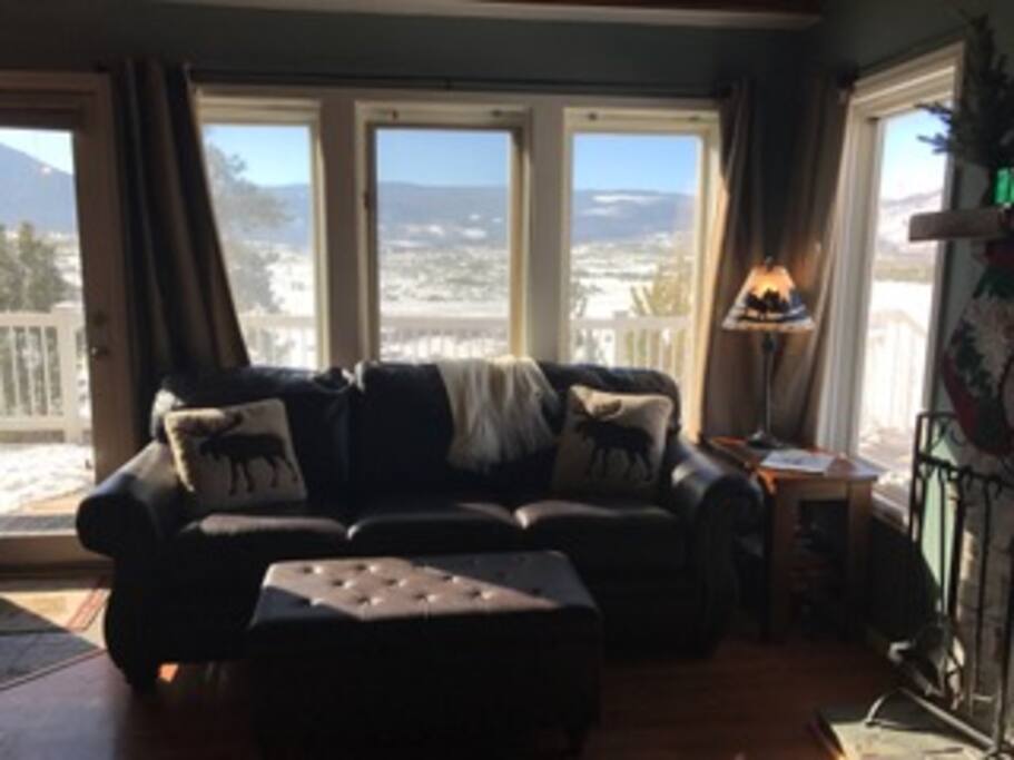 Family room looks over snowy mountain range