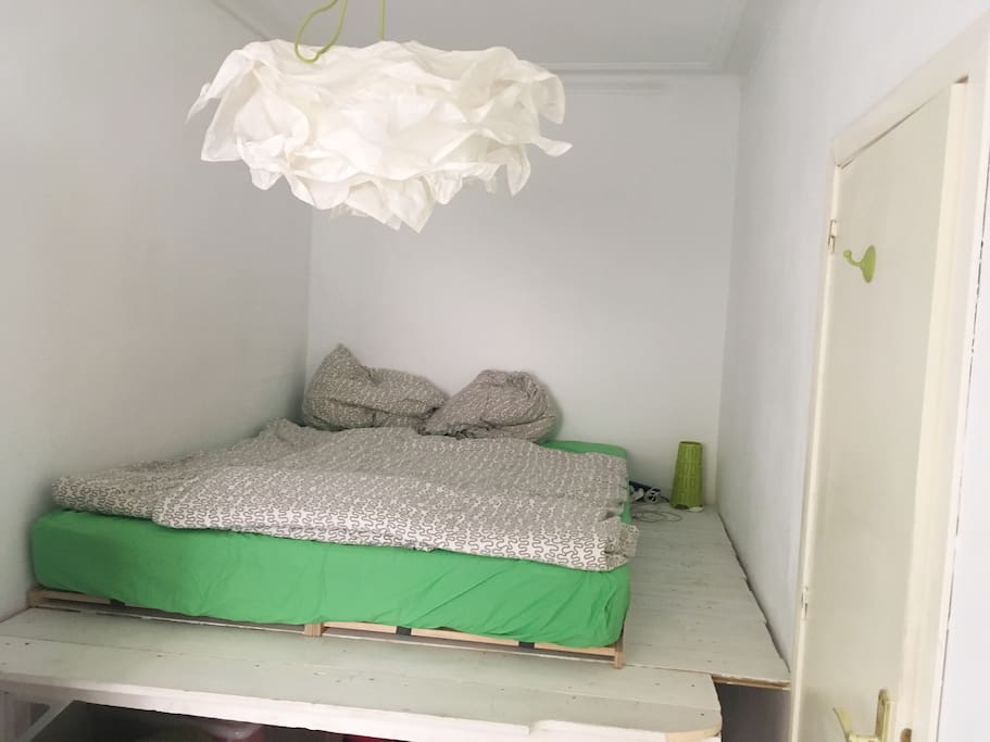 Sleeping room with window and wardrobe.