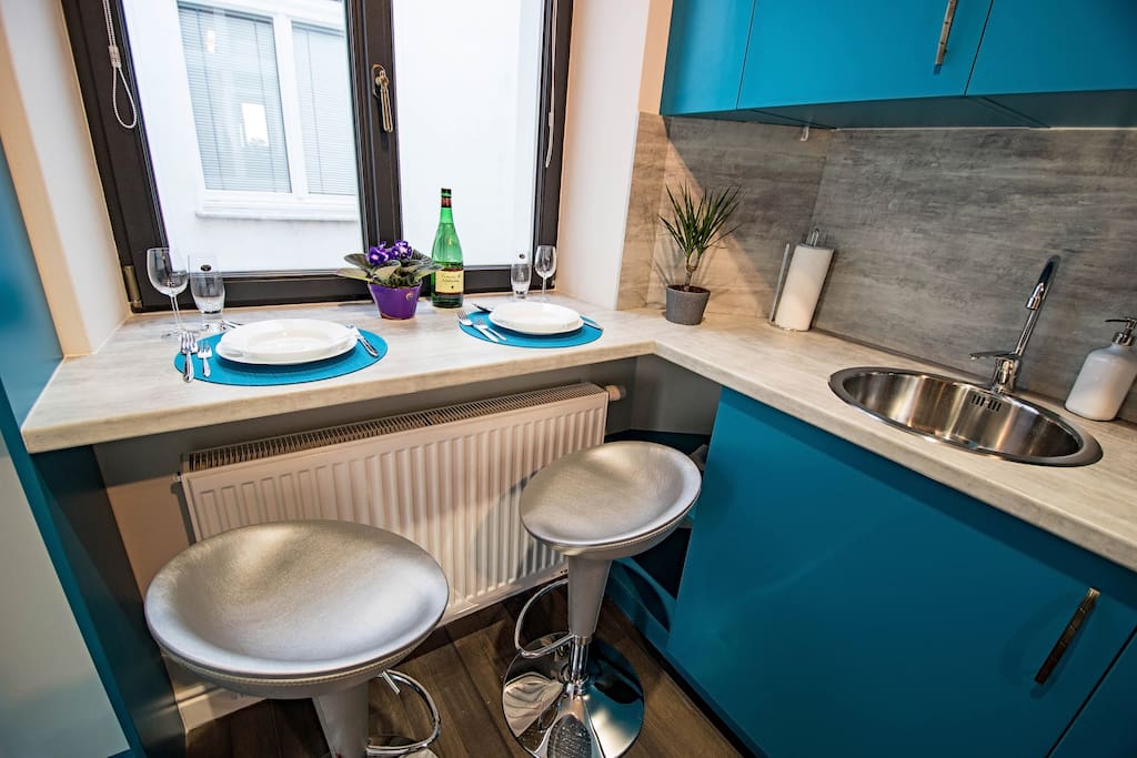 Small but cozy kitchenette with dining table in the apartment