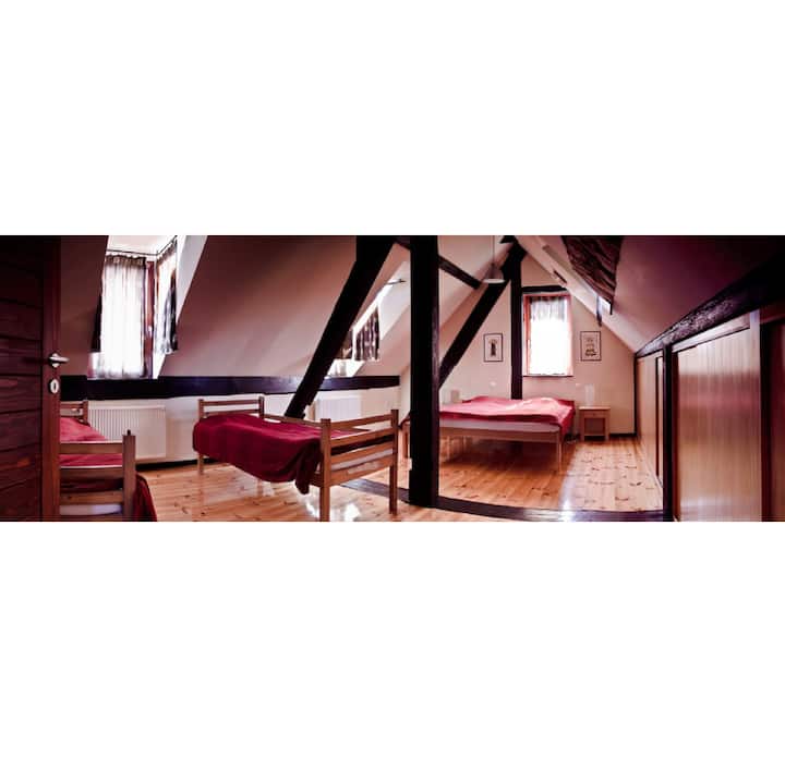 One of the bedrooms upstairs with 2 single and one king size bed