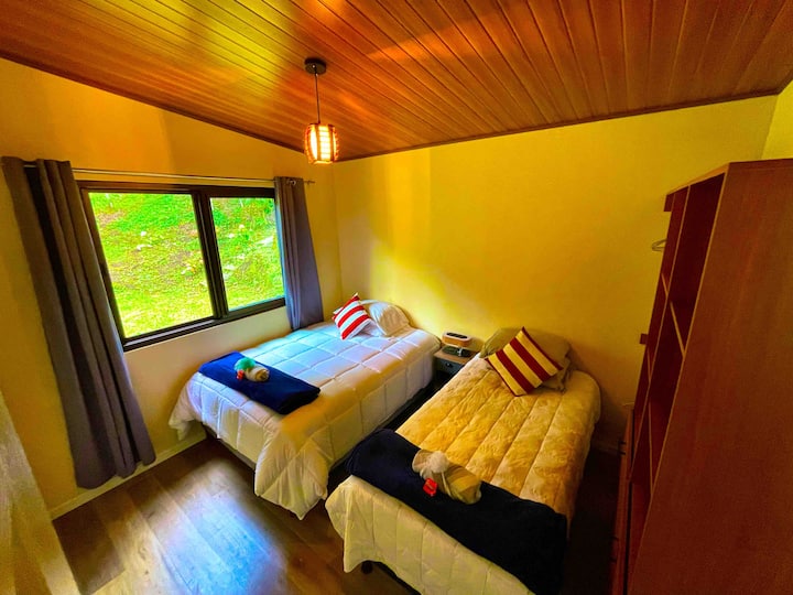 Room with two beds and space for storage of clothes