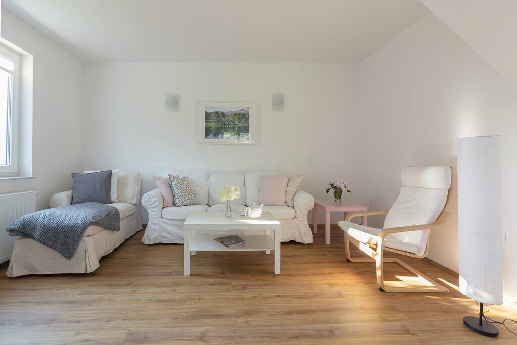 A comfortable sitting room with two coffee tables and a flat screen TV with as many as 265 international TV programmes (including HD programmes).