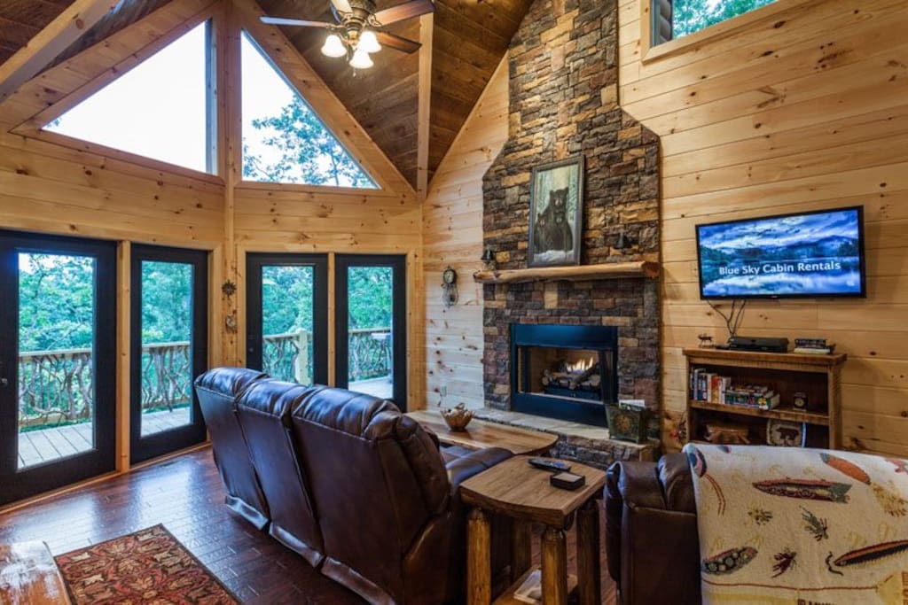 Great Room with a stacked stone gas fireplace,42 inch flat screen TV and lots of windows