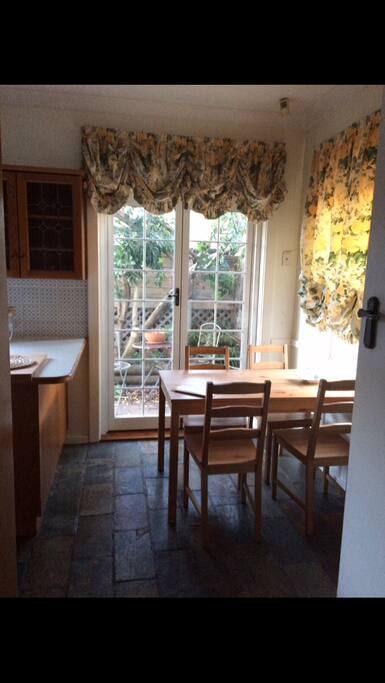 French doors open to a shady courtyard