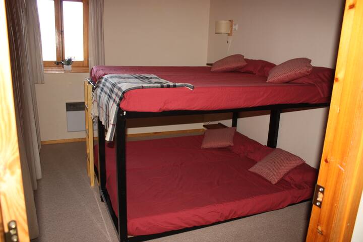 חדר שינה עם שתי מיטות קומתיים בקומה השנייה