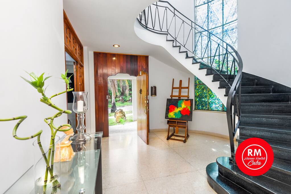 Villa entrance door on the left access to the livings and rest areas on the right stairs to the second level.