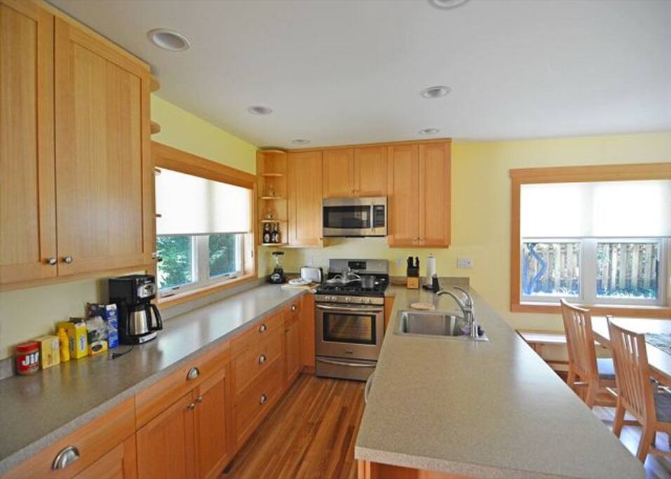 A beautiful, well appointed kitchen looks out over an open dining and living room area - perfect for everyone in the family to join in the conversation!
