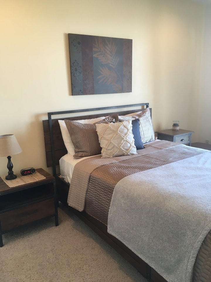 Guest Bedroom has two side tables, table lamp and a alarm clock with built in usb charger