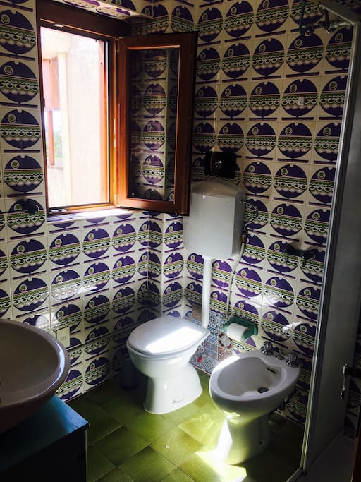 Bathroom with shower, toilet, sink and bidet