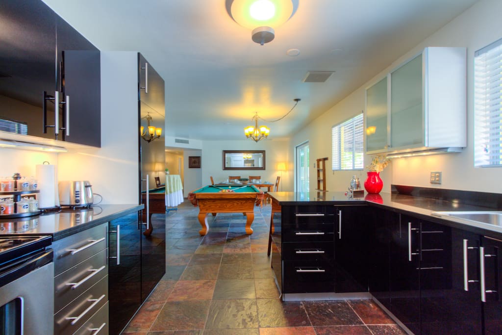 The kitchen opens to the billiard and dining area.