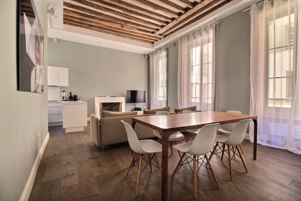 Luminous living room with dining area, sofa and TV