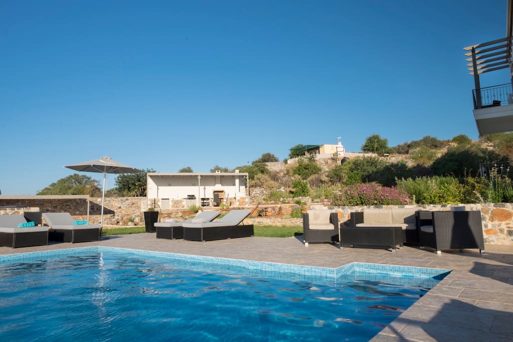 Infinity pool looking towards the new patio, pergolas and outdoor kitchen