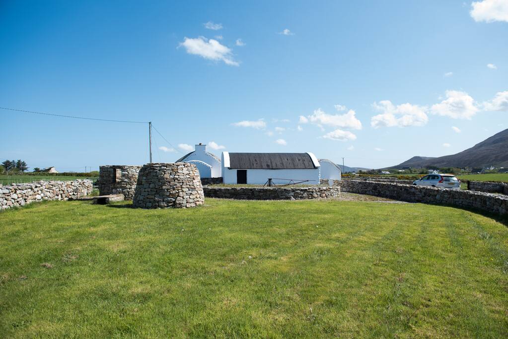 Dan's Cottage from entrance -private farm grounds with traditional stone features such as grinding mills and smoke house.
