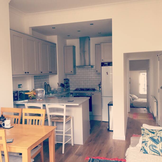 Open plan living room and kitchen with marble breakfast bar