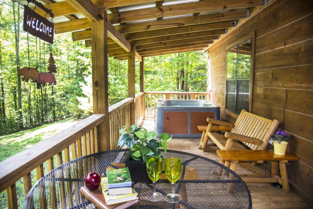 Porch features a hot tub and gas grill.