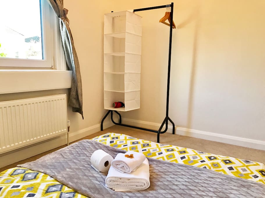 Carpet Floor with Clothes Rail and hairdryer in room + clothes hangers and space for clothes