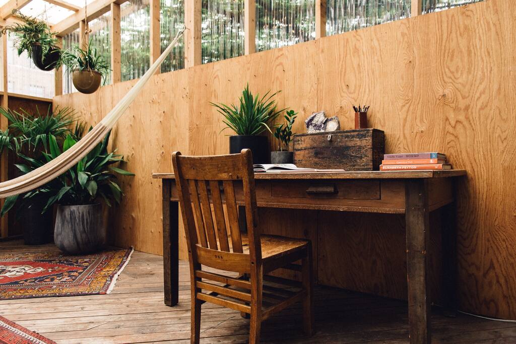Vintage School Desk in the sunroom. This is a great place to get work done or you can clear the table and pull it out for a shared meal with friends.