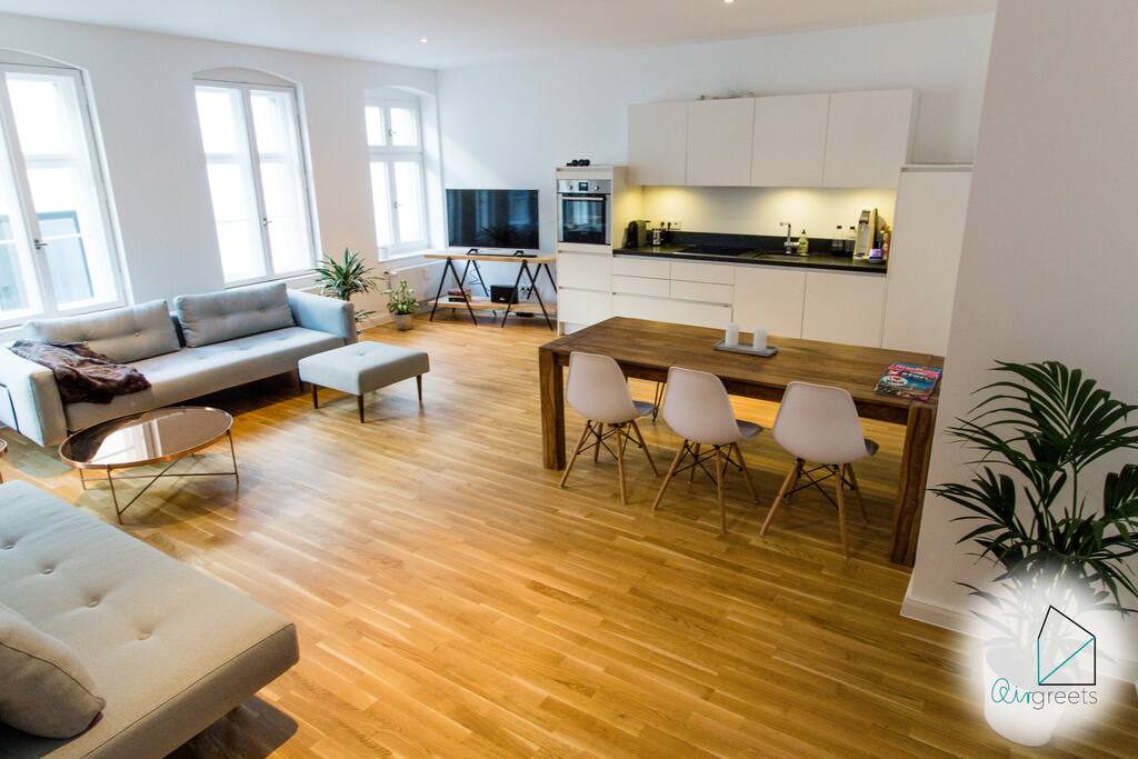 The living room is furnished in a modern and minimalistic way, but yet you can feel the old-building charm.