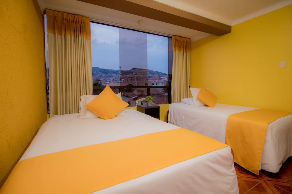 Twin bedroom with city and mountains view
