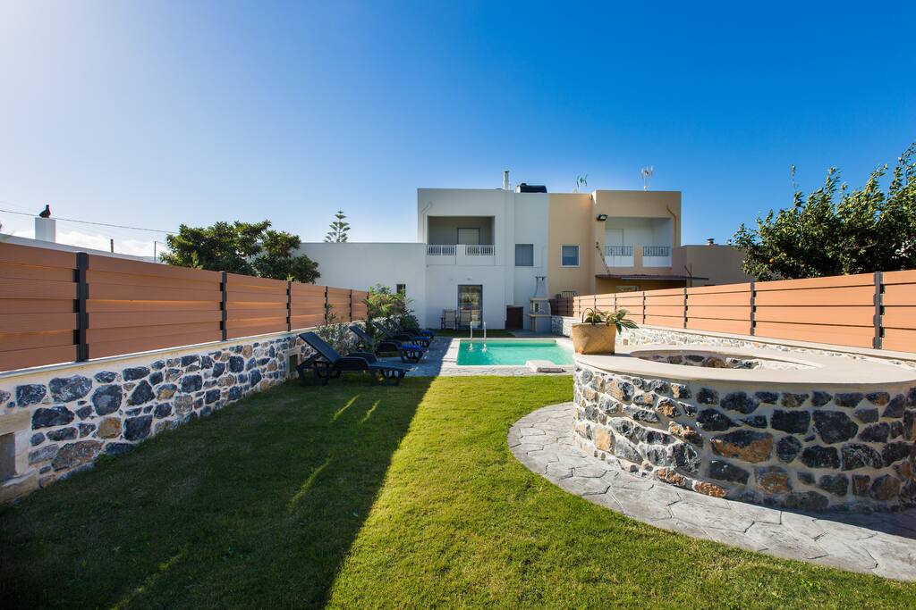 Private swimming pool area with sun beds and umbrellas