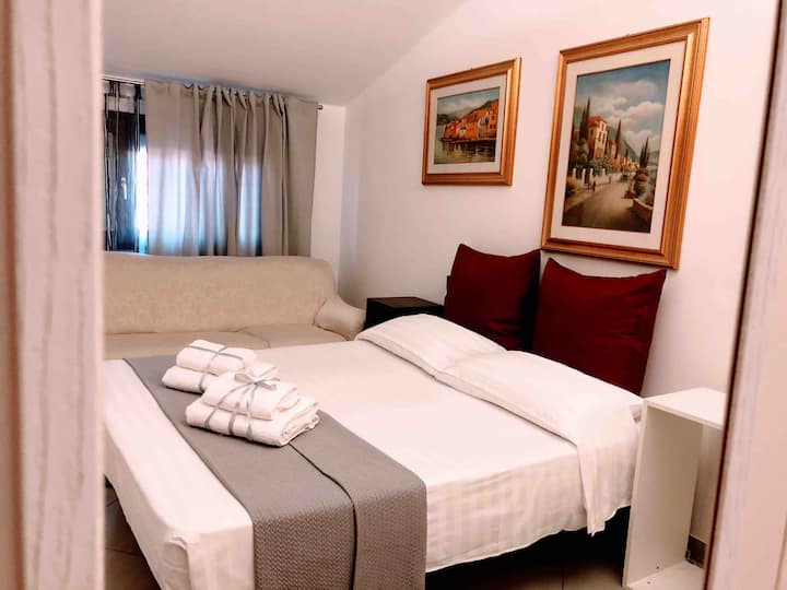 Romantic room with large closet and sofa. The paintings are reminiscent of the proximity to Lake Garda