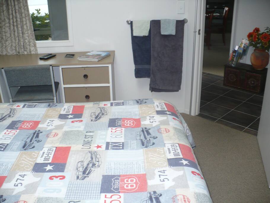 Queen bed showing direct entrance from front door.