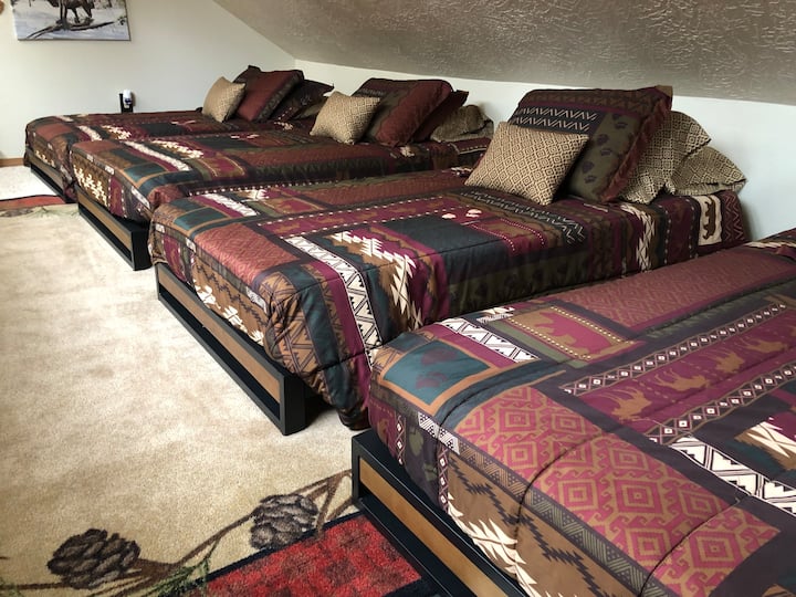 Bunk room (ladder access) with four twin beds and sitting area. 